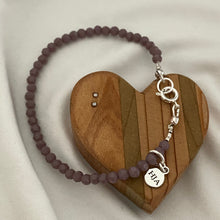 Load image into Gallery viewer, Purple tiny beads, minimalist bracelet, sterling silver clasp and accent beads on a wooden heart