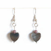 Load image into Gallery viewer, Heart-shaped earrings with purple beads on a white background