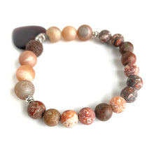 Load image into Gallery viewer, Rusts, Browns, Creams, and Champagne meld into a stunning diffuser bracelet with a brown glass heart charm. Silver Spacer Beads. Apply 1-2 drops of your favorite essential oil on the brown lava stone - breathe deep and fill your heart with gratitude. Type: Diffuser Bracelet Size: 7 Beads: 8 mm Leopard Jasper, 10 mm Amber Agate, 10 mm lava stone