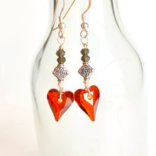 Load image into Gallery viewer, A radiant red crystal heart dangles from gray quartz and Sterling Silver ear wires. Simple, stately sentiment of love. Collection: Jo Color: Red Drop Length: 2 inches Materials: Swarovski crystal, quartz Metals: mixed, .925 Sterling Silver ear wires