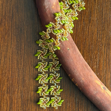 Load image into Gallery viewer, Close up of beaded vortice bracelet in green and gold
