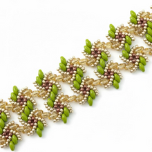 Load image into Gallery viewer, A close-up of a beaded bracelet laid diagonally on a white surface. The jewelry features repeating floral clusters with bright green beads, faceted gold beads, and small metallic rose-gold/copper-toned beads.
