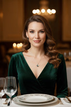 Load image into Gallery viewer, Woman dressed up for a dinner out, wearing heart-shaped pendant necklace  and a v-neck dress.
