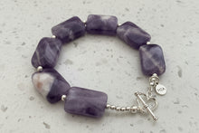 Load image into Gallery viewer, Amethyst bracelet with sterling silver accents and heart clasp on a marble background
