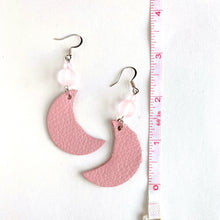 Load image into Gallery viewer, Pink leather half-moons hang from translucent pink glass beads. Sterling Silver ear wires. Light-weight.  Collection: Leather Color: Pink Drop Length: 2 3/4 inch Materials: Leather, Glass Metals: mixed silver, .925 Sterling Ear Wires
